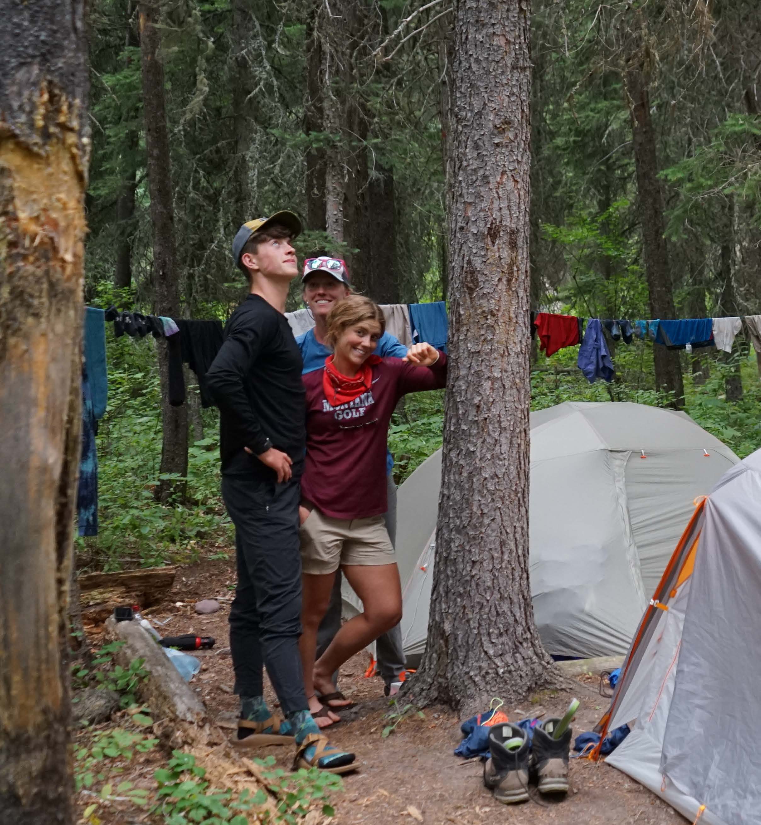 Teigan setting up camp site in the woods